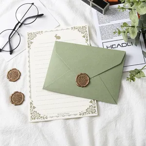 Avocado green envelope and writing paper stationery set with wax seal stamp for letters.