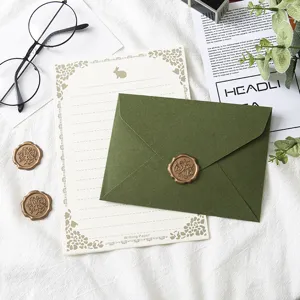 Avocado green envelope and stationery letter paper set with vintage design details.