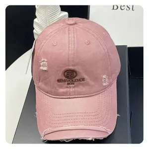 Distressed pink baseball cap with embroidered logo, soft top and adjustable strap for women.