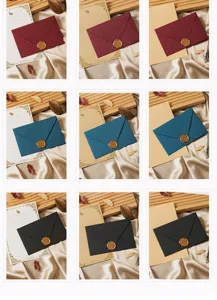 Detailed view of vintage stationery set with colored envelopes, writing paper and wax seals.