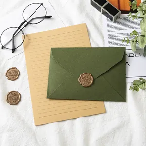 Detail shot of vintage avocado green envelope and lined letter paper set with wax seal.