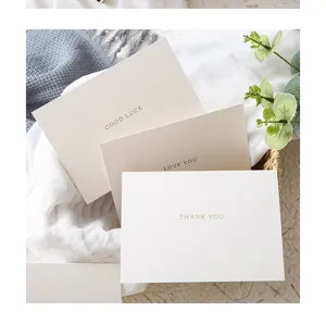 Detailed view of textured greeting cards with elegant gold foil lettering for various occasions.