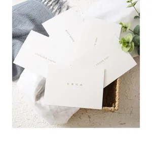 Detail shot of elegant blessing greeting cards with golden typography displayed in a basket.