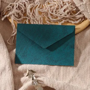 Dark green textured envelope detail shot, minimalist vintage style stationery for letters.