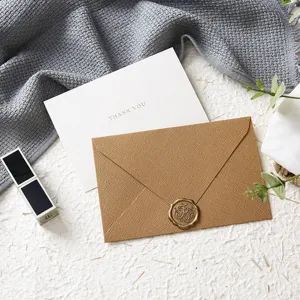 Detail shot of textured envelope with wax seal and thank you greeting card for celebration.