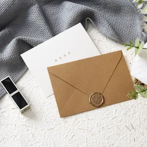 Detailed view of burlap textured greeting card envelope with wax seal for special occasions.