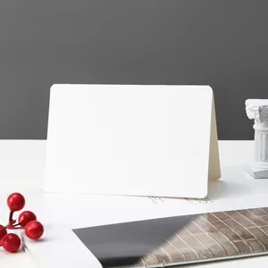 Blank folded paper card detail shot, minimalist white card for hand drawing and greeting card use.