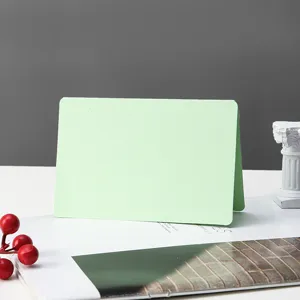 Blank folded card detail showing green surface and paper texture for DIY hand painting and notes.