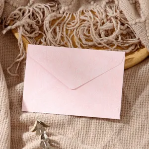 Pink vintage style paper envelope with texture, perfect for romantic letters and wedding invites.