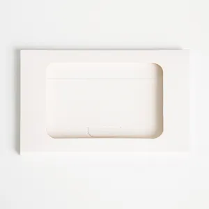Detail d'enveloppe en papier blanc, porte-carte au design minimaliste, texture lisse fine.