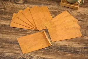 Vintage kraft paper envelopes detail shot, antique stationery layout on wooden table background.