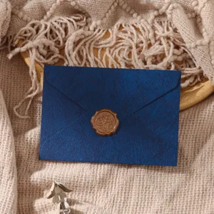 Dark blue textured envelope with wax seal, vintage stationery style detail shot for romantic letters.