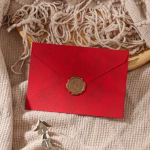 Detailed shot of retro red textured envelope with golden wax seal for romantic letters.