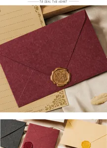 Vintage stationery set detail featuring a textured envelope, decorative paper, and wax seal.