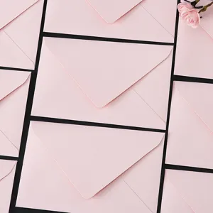 Detail shot of pink paper envelopes, flat lay arrangement, smooth texture for love letters.