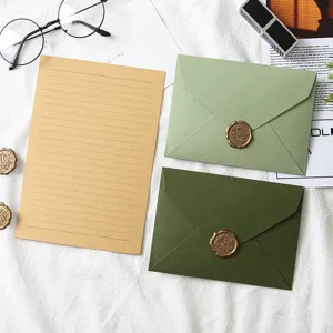Avocado green stationery set with envelopes and lined paper for greeting cards or letters.