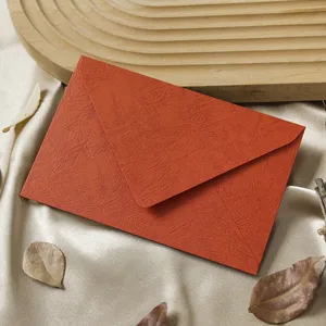Orange textured envelope detail shot, retro special paper stationery for vintage letters and invitations.