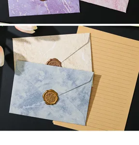 Set di buste in marmo vintage e carta da lettere rigata con sigillo per matrimonio.