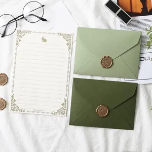 Avocado and olive green stationery set with envelopes, writing paper, and retro wax seals.