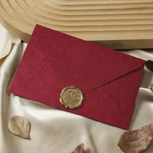 Vintage red textured envelope with gold wax seal, classic retro design for cards and letters.