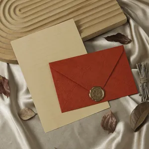 Retro stationery set featuring a textured red envelope, wax seal stamp, and lined kraft letter paper.
