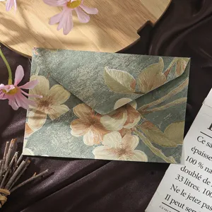 Close-up detail of retro Chinese style floral embossed envelope with elegant gold pattern.