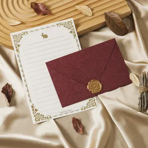 Detailed view of vintage stationery letter paper and dark red envelope with wax seal design.