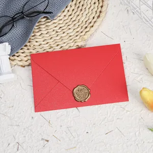 Red pearlescent envelope with wax seal detail, elegant stationery item for special notes.