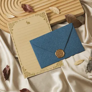 Vintage stationery detail showing kraft paper, blue envelope, and golden wax seal.