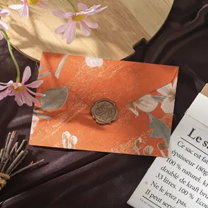 Vintage floral design paper envelope with decorative wax seal, elegant stationery letter set detail.