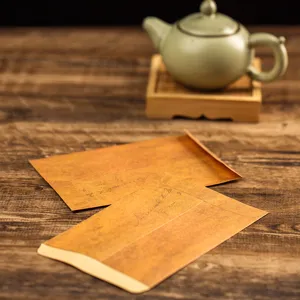 Detailed view of vintage kraft paper envelopes and letter set for retro handwritten messages.