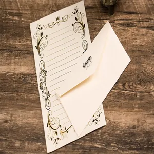 Vintage gold foil stationery detail featuring elegant floral borders and matching envelope.