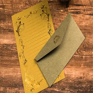 Close-up detail of vintage gold-stamped stationery letter paper and matching envelope set.