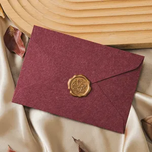 Retro dark red envelope detail with exquisite golden wax seal for romantic stationery.