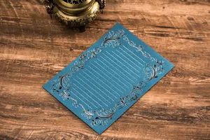 Vintage blue letter paper with silver foil floral patterns and lined design for writing letters.