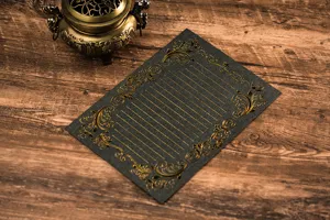 Vintage hot-stamped black stationery paper featuring gold floral border and lined layout.