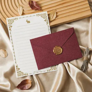Vintage stationery set with retro letter paper and burgundy wax seal envelope for romantic letters.