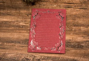 Red vintage letter paper with elegant foil floral borders and writing lines for stationery needs.