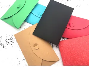 Close-up view of colorful paper envelopes with heart clasps, perfect for creative stationery sets.