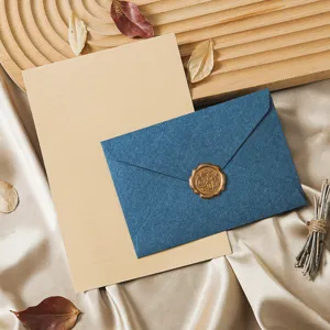 Vintage style blue envelope and lined stationery paper set with elegant wax seal, detail view.