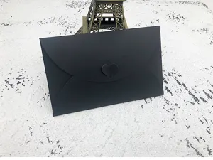 Black envelope with heart clasp detail, elegant stationery design for greeting cards and letters.