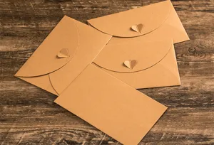 Kraft paper envelopes with heart buckle set, vintage stationery for letters and greeting cards.