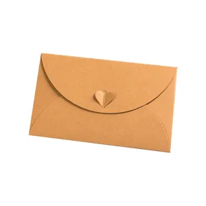 Kraft paper envelope detail shot, creative heart buckle design, vintage style stationery.