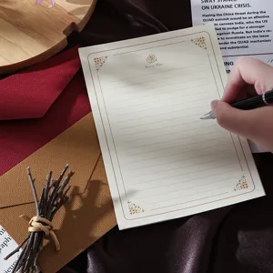 Vintage letter paper and envelope set with golden rose border for romantic writing.