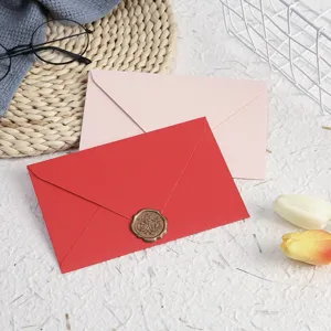 Close-up detail of colored paper envelopes with wax seal stamp and stationery set.