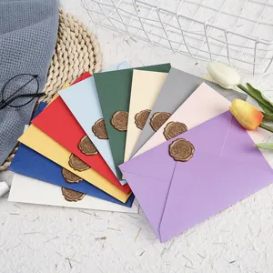 Colorful pearlescent envelopes set with vintage wax seals for letters and greeting cards detail view.