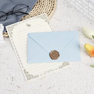 Elegant stationery set featuring vintage letter paper, blue envelope, and retro wax seal.