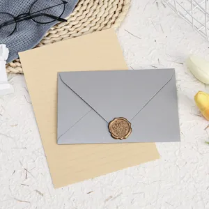 Detailed view of a grey pearlescent envelope and lined stationery paper set with wax seal.