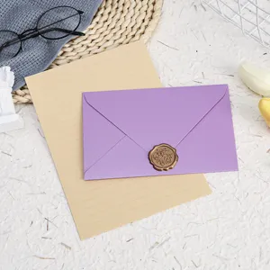 Stationery letter paper and purple envelope set with wax seal for greeting cards or letters.