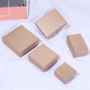 Elegant champagne gold jewelry gift boxes in various sizes displayed on white fabric